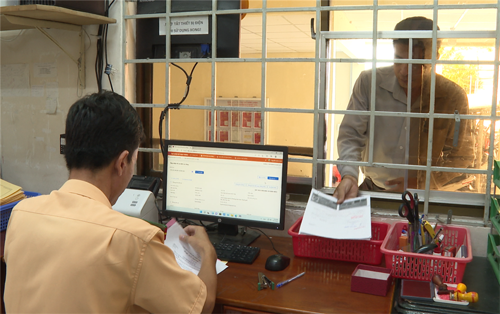 Cảnh sát giao thông giải quyết hồ sơ, thủ tục đăng ký xe của người dân thông qua dịch vụ công.