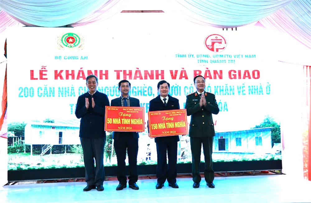 Thứ trưởng Phạm Thế Tùng; đồng chí Nguyễn Đăng Quang, Chủ tịch Hội đồng nhân dân tỉnh Quảng Trị trao biển tượng trưng tặng nhà tình nghĩa cho lãnh đạo Ủy ban nhân dân hai huyện Hướng Hóa và Đakrông.