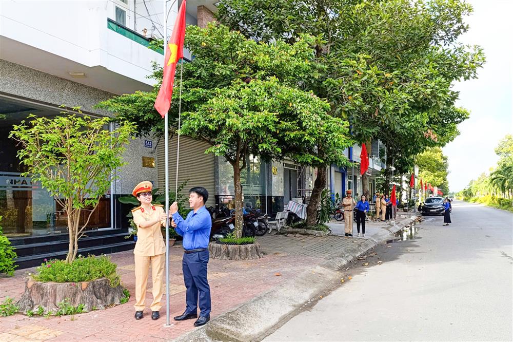Đại biểu thực hiện nghi thức treo cờ Tổ quốc.
