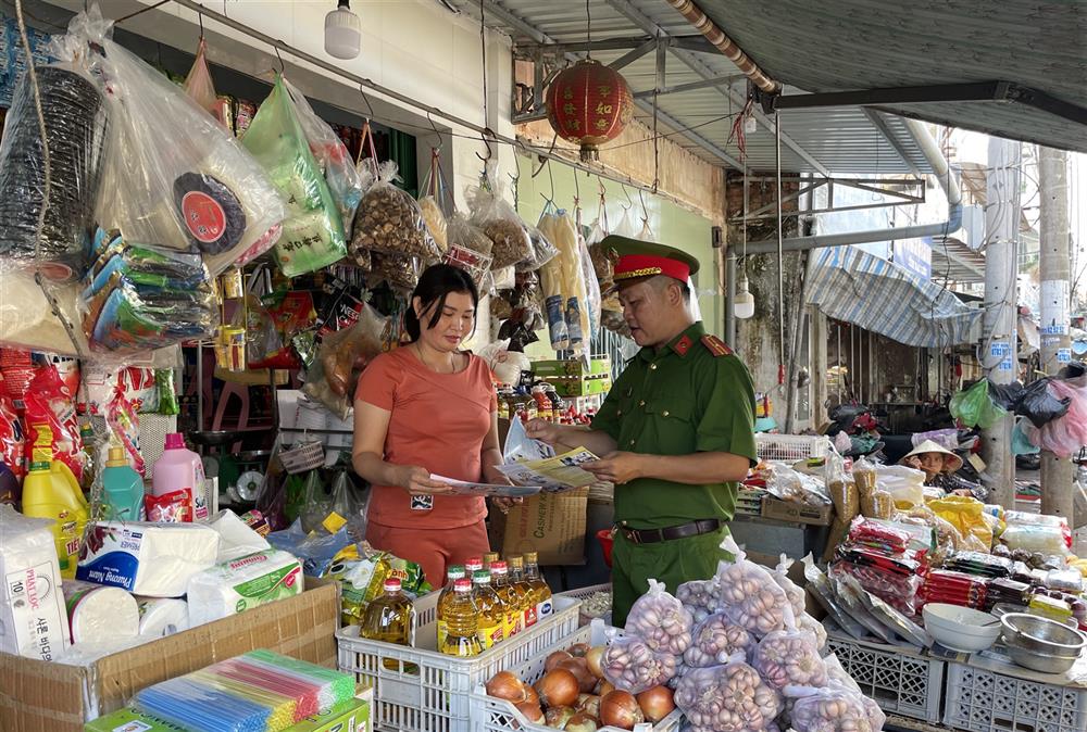 Lực lượng Cảnh sát kinh tế phát tờ rơi tuyên truyền về vệ sinh an toàn thực phẩm.