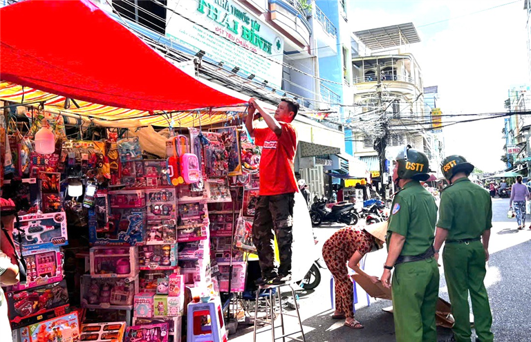 Lực lượng Cảnh sát trật tự nhắc nhở người dân không lấn chiếm vỉa hè, lòng, lề đường, hành lang an toàn giao thông tại phường Mỹ Long, thành phố Long Xuyên.