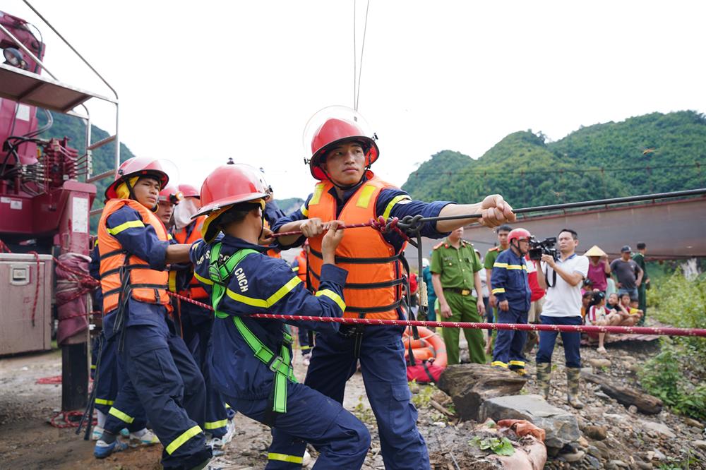 Cảnh sát Phòng cháy, chữa cháy và cứu nạn, cứu hộ dùng dây néo 2 bờ sông để phục vụ công tác cứu nạn.