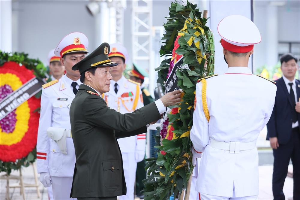 Bộ trưởng Lương Tam Quang chỉnh vòng hoa trước khi vào kính viếng Tổng Bí thư Nguyễn Phú Trọng.