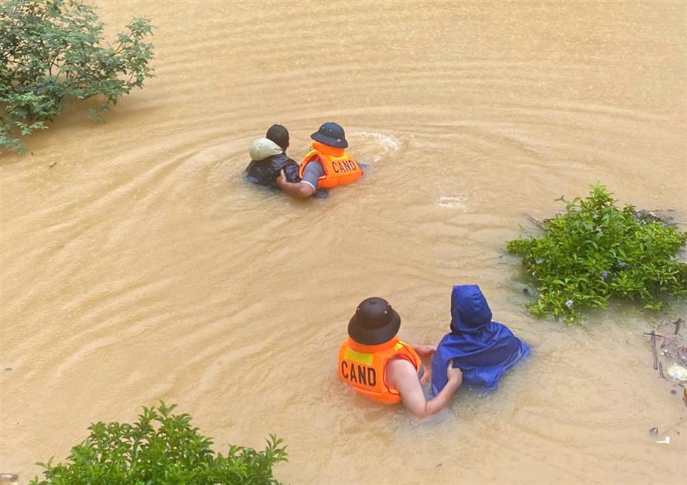 Lực lượng chức năng di chuyển người dân ra khỏi vùng lũ tại Bảo Thắng.