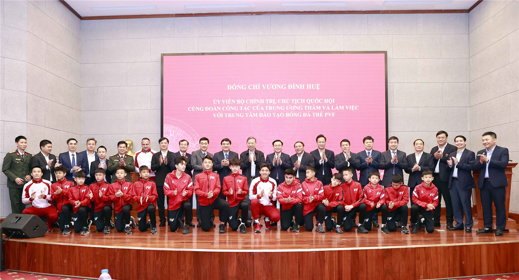 Chủ tịch Quốc hội Vương Đình Huệ và đại biểu chụp ảnh lưu niệm với cầu thủ, huấn luyện viên tại Trung tâm đào tạo Bóng đá trẻ PVF.