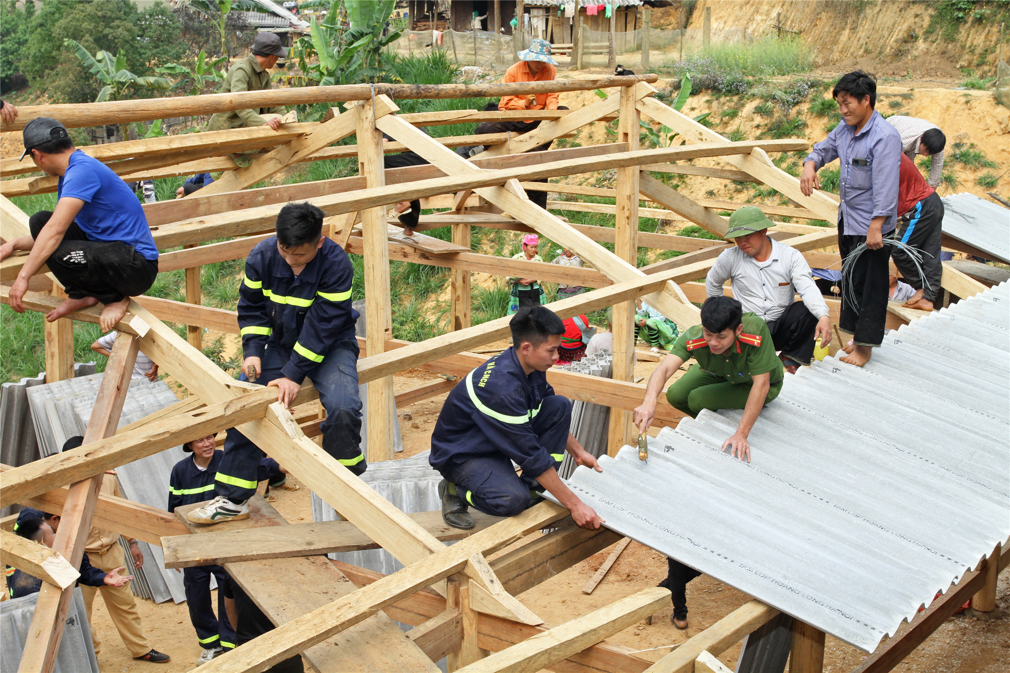 Đoàn viên thanh niên Công an tỉnh Yên Bái tham gia vận chuyển nguyên vật liệu và hỗ trợ người dân xóa nhà tạm, nhà dột nát.