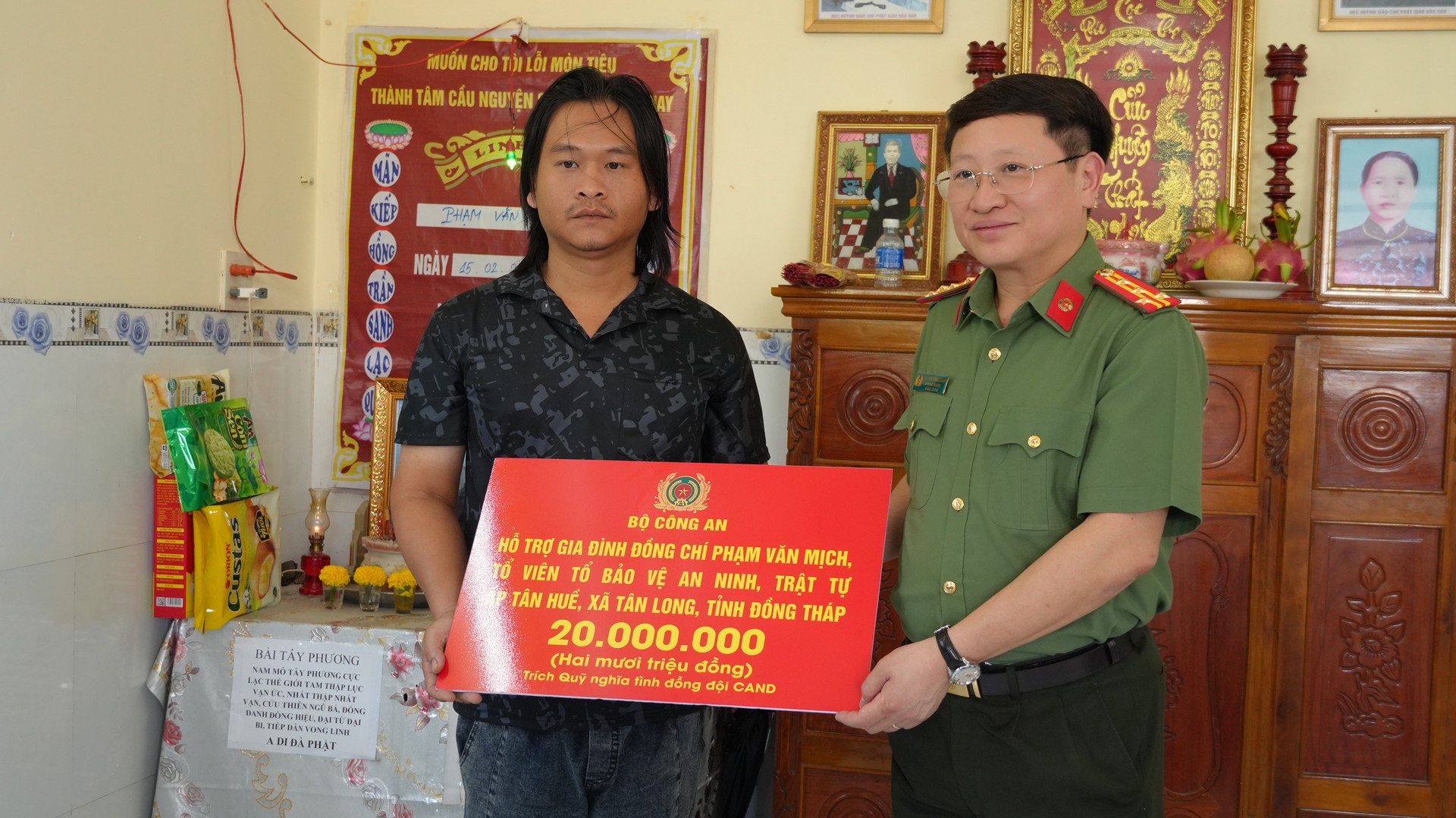 Đại tá Nguyễn Thanh Bình, Phó Cục trưởng Cục xây dựng phong trào bảo vệ an ninh Tổ quốc, Bộ Công an trao tiền hỗ trợ gia đình đồng chí Phạm Văn Mịch. Ảnh Trọng  Tín.JPG